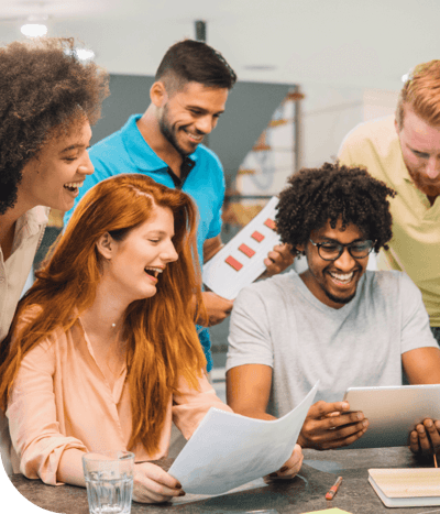 Team members discussing something in an office together.