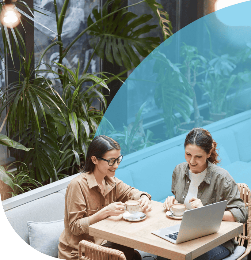 Two women having a virtual meeting in a cafe.