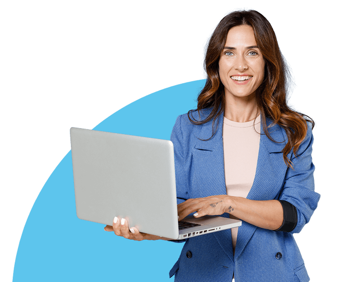Woman looking happy whilst holding her laptop.